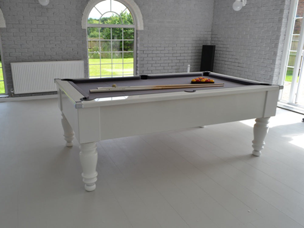 Gloss White Turned Leg Pool Table with grey cloth and chrome corners image on white wooden floor..