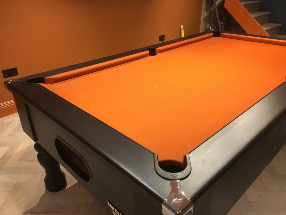 British made, solid-wood turned leg elegant pool table, featuring chrome corners and stunning modern matt finish. Orange cloth complimenting finish.