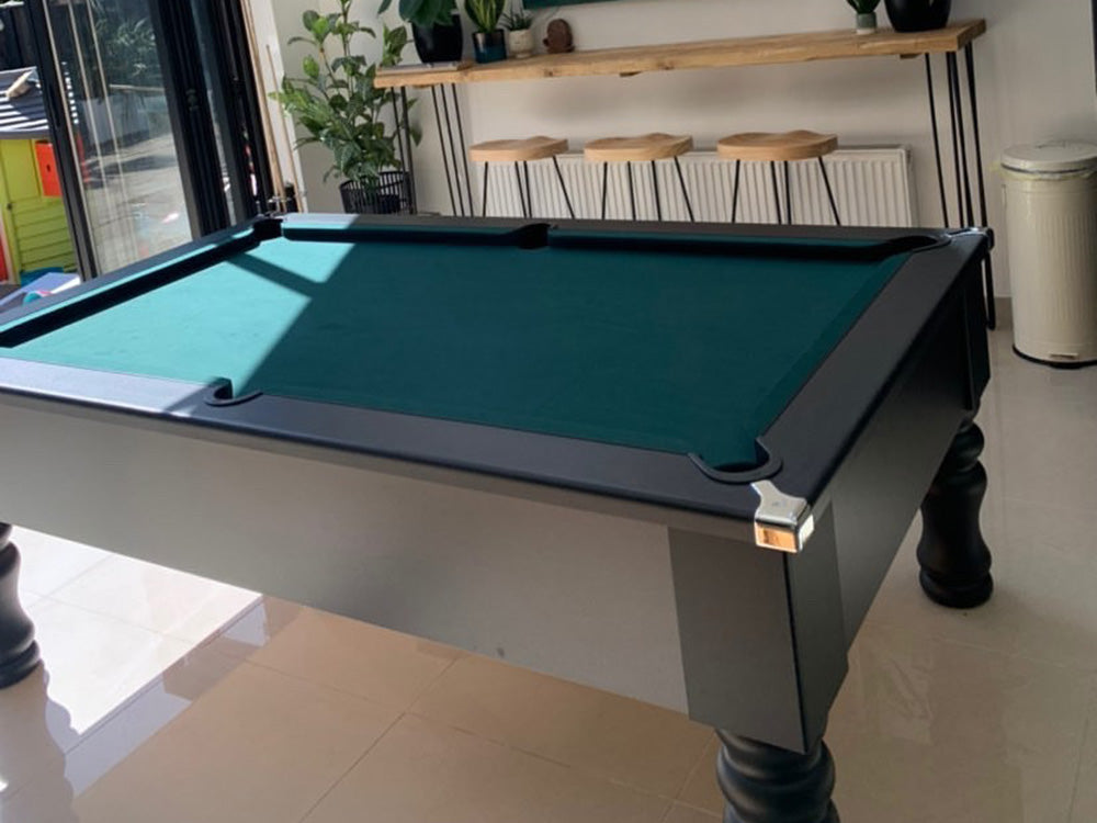 British made, solid-wood turned leg black pool table 7ft, featuring chrome corners and stunning modern matt finish. Green cloth finish. 