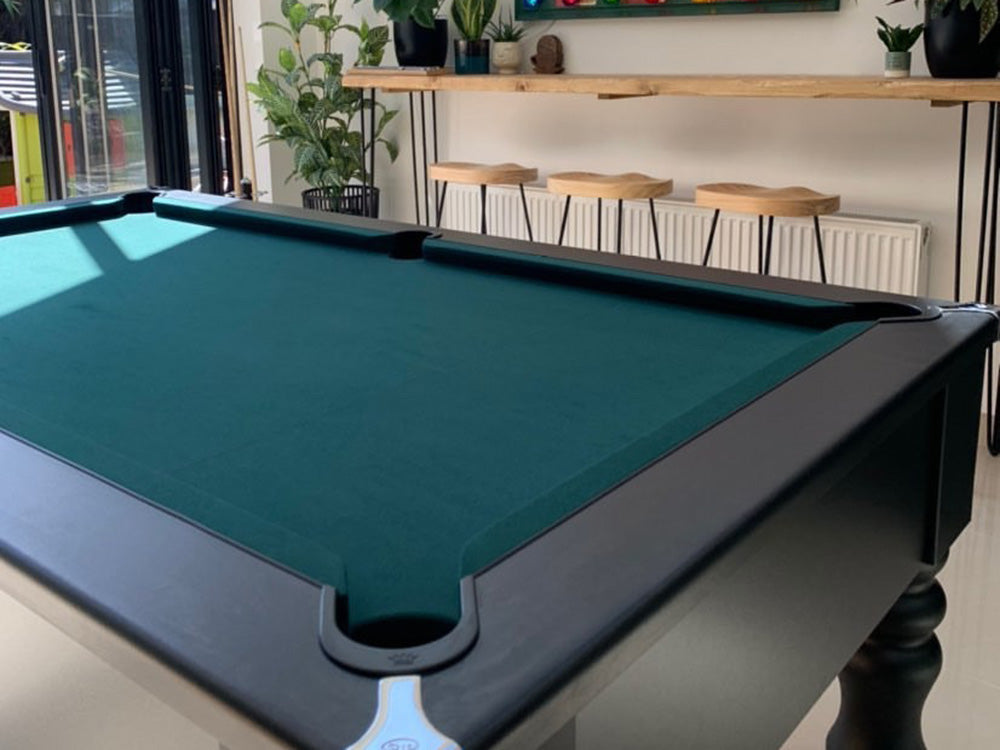 British made,turned leg solid-wood 6ft pool table uk, featuring chrome corners and stunning modern matt finish. Green cloth.