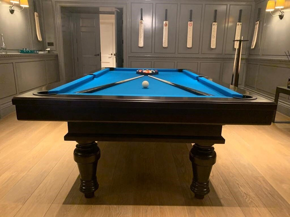 Elegant Pacha Pool Table in Black with electric blue cloth looking down pool table.